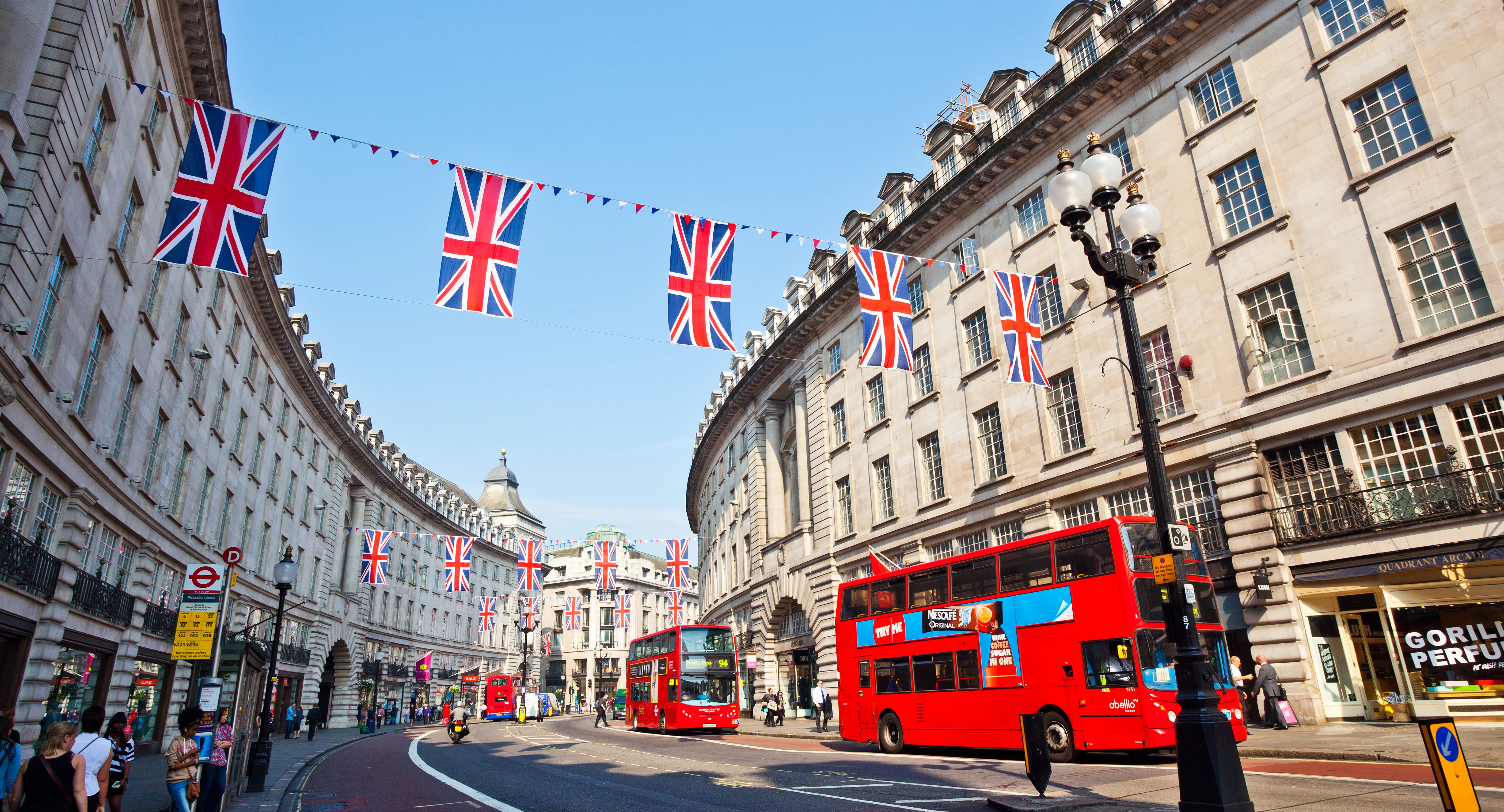 London street with red buses and Union Jack flags
