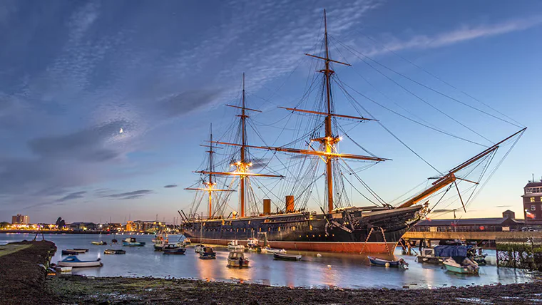 HMS Warrior in Portsmouth Harbour at dusk
