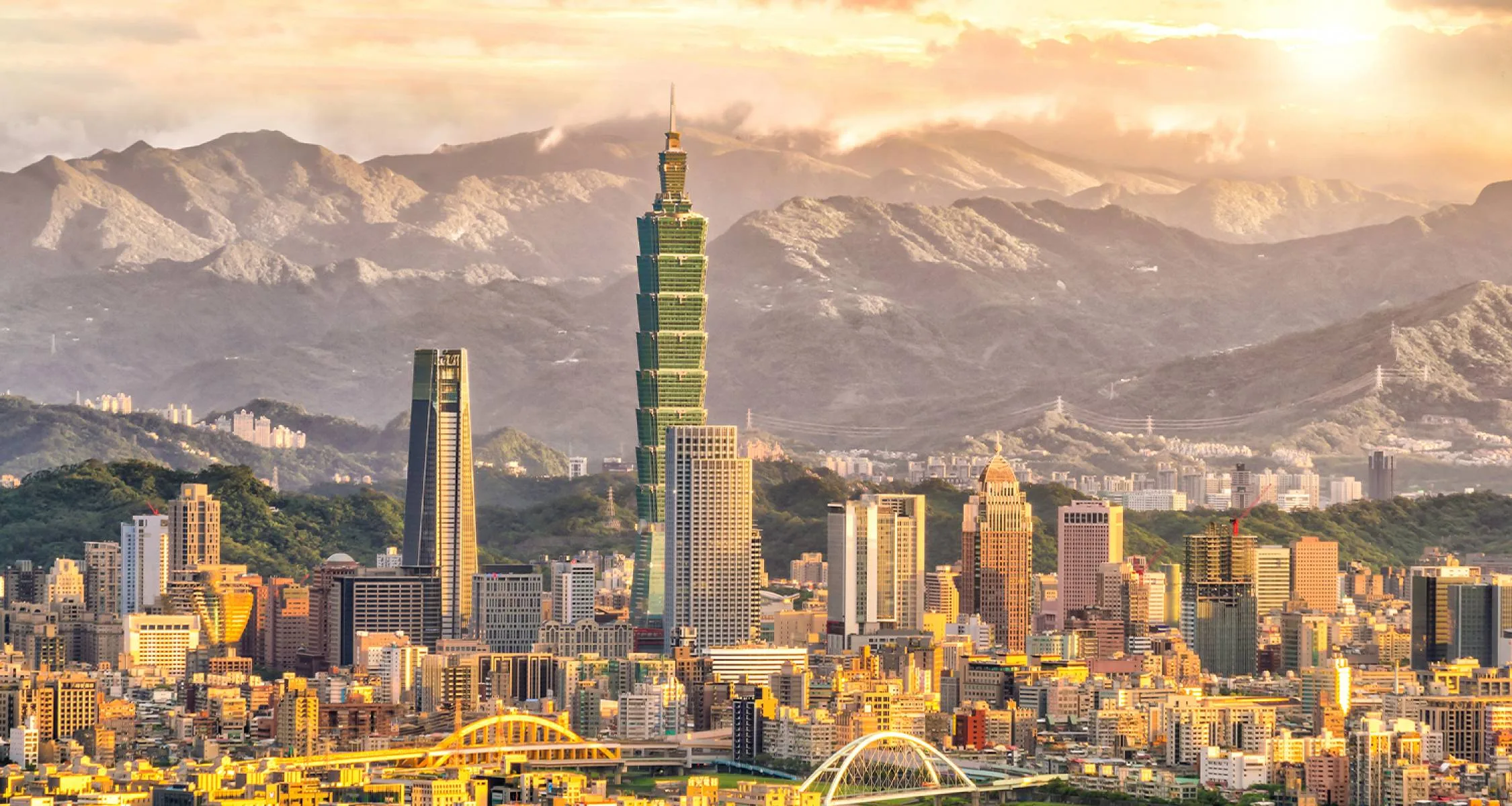 Taipei 101 skyline with mountains behind the city